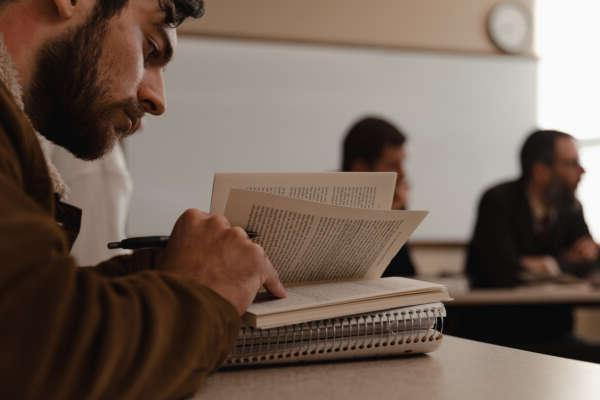 A student reads a book in a seminar class